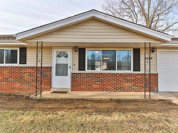 Crisp and clean exterior with garden beds awaiting your personal touch.