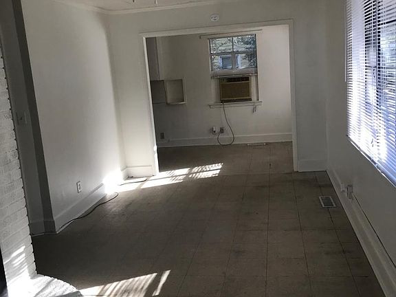Front entrance into living room, view into dining area