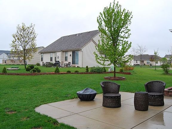 Brick landscaping and lighting under each tree and back foliage