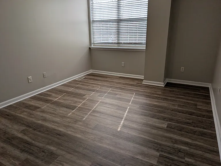 Spacious upper-level bedroom suite with new luxury vinyl plank flooring and bright natural lighting