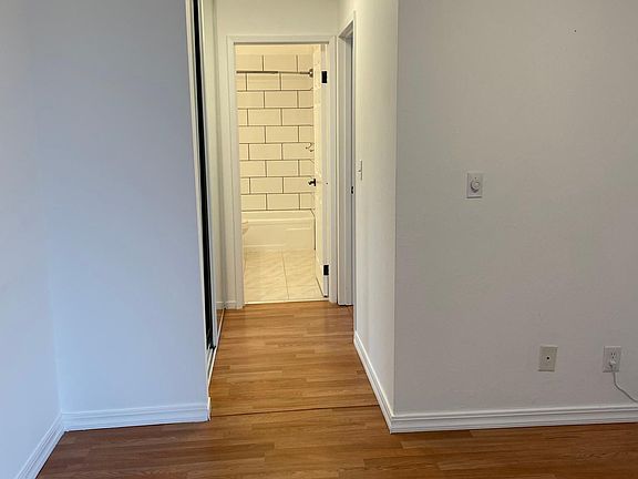 HALLWAY WITH HUGE CLOSET CROWN MOLDING AND BASEBOAD