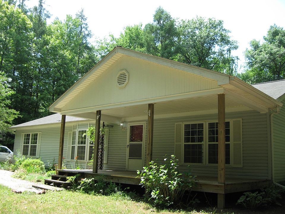 A outdoors man dream! A secluded Sanford Lake subdivision. with boat launch and Lake access close by, Fishing for the big one that got away; then  state land is practically around the corner. Just waiting for the right buck to come into your sights. Enjoy the large front porch to sit and watch the fall colors and the  Koi pond complete with a family of turtles. 2 x 6 construction adds  extra insulation for energy efficiency. Vaulted dining and living areas, ceiling fans and split bedroom situation with the master bedroom at the opposite end away from the other 2 bedrooms. Master bath includes a garden tub, second hallway bath serves the other 2 bedrooms.  Lots of land for kids to play and a great 3 car garage with a 2 car door. City water is at the road.  Home is wired for a future generator.  Modestly  priced home in a prestigious lakeside neighborhood. Surround yourself  with  quiet nature or you can walk down  to the lake access to do some fishing or boating. Best of both worlds, 
