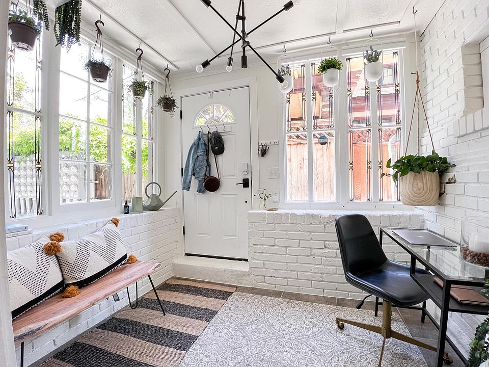 Charming front room providing plenty of light for plants, work, and even some yoga