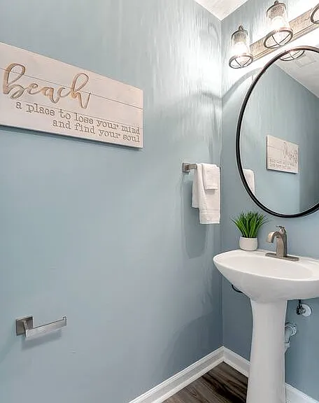 Powder room off living room and kitchen.