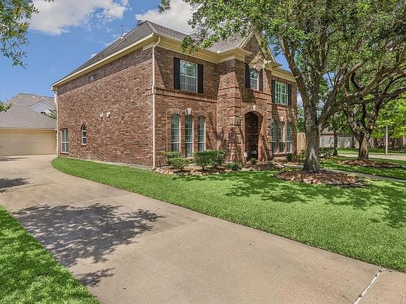 A long driveway leads to a 3-car detached garage!