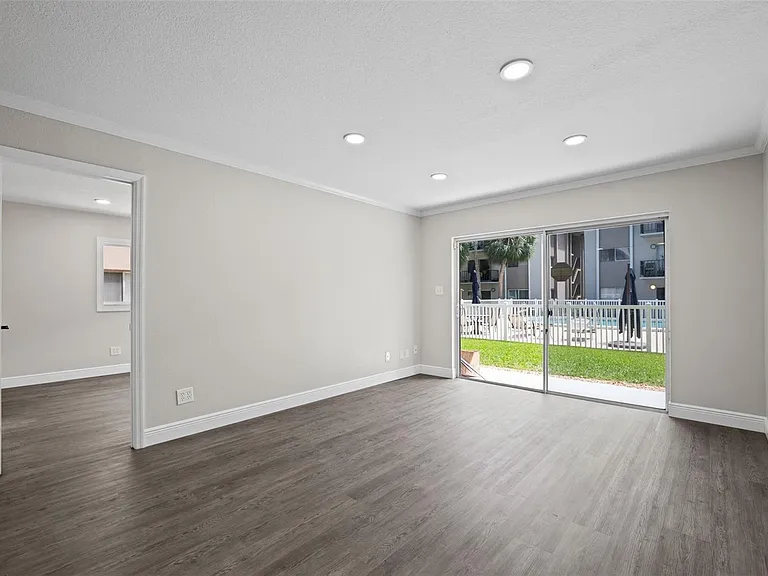 Dining area to primary bedroom and sliders to pool