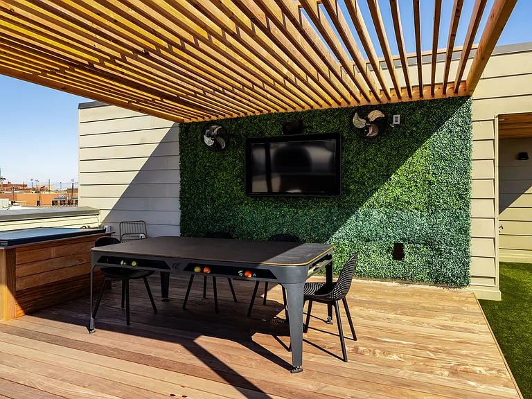 Enjoy your private patio on the 3rd floor. There is plenty of seating either under the pergola or not, there is a pool table that doubles as a table, TV, fans, and corn hole.