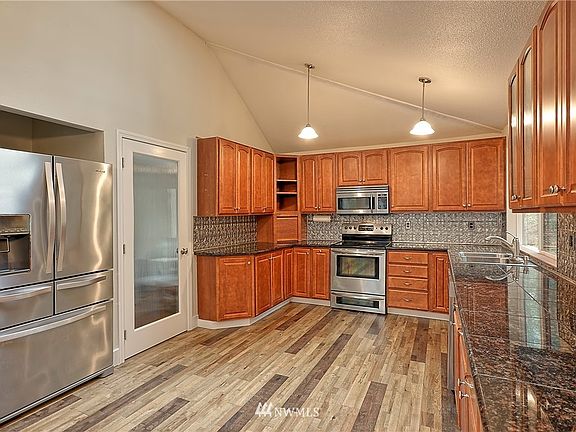 Kitchen features vaulted ceilings and huge walk-in pantry, large enough for wine storage and additional freezer.
