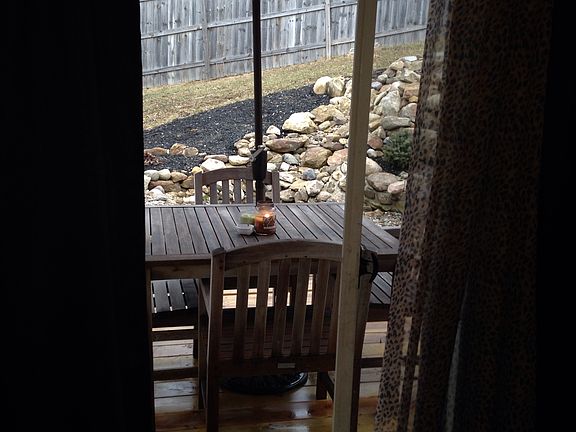 View of backyard landscaping in deck from master bedroom suite