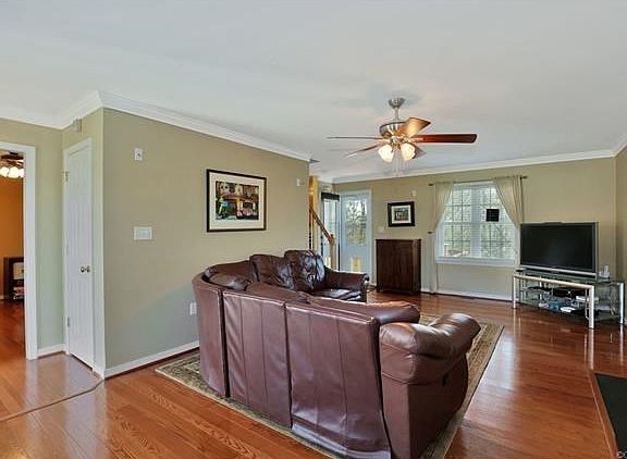Family room - hardwood flooring, crown molding, door to deck