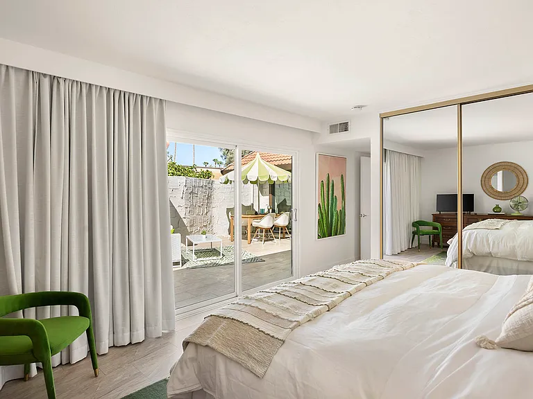 Primary Suite with Cal King Bed. This room has direct access to front patio leading to pool area.