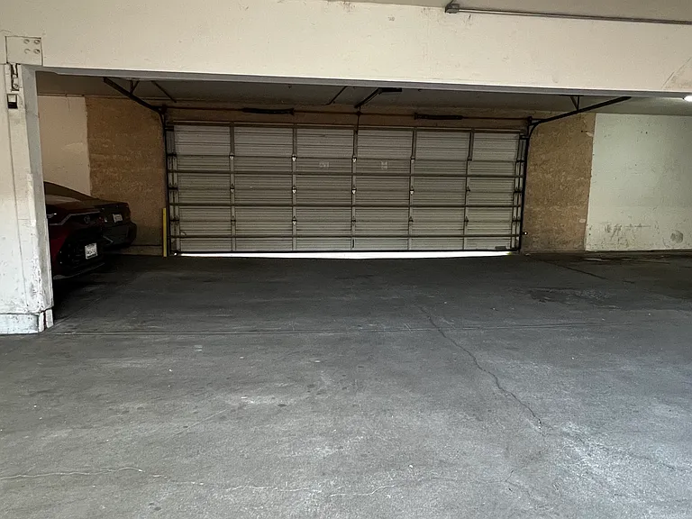 Amenities include one designated parking space in a gated garage, 24/7 surveillance cameras