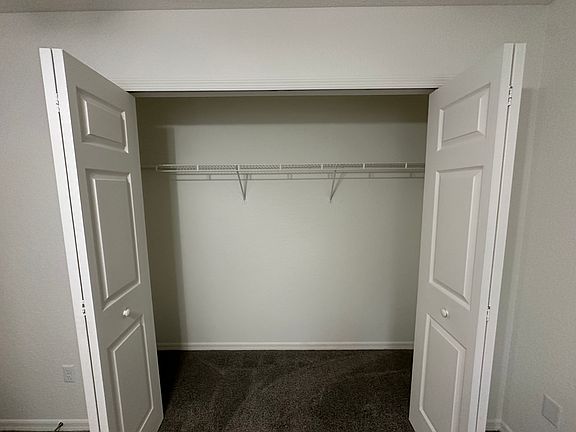 Walk in closet in roommates bedroom