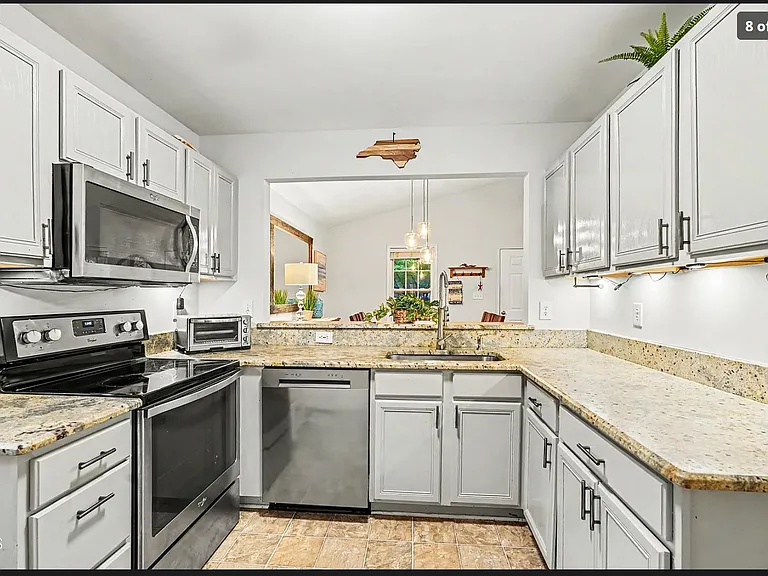 Kitchen. The refrigerator is on the left wall as you enter the kitchen.