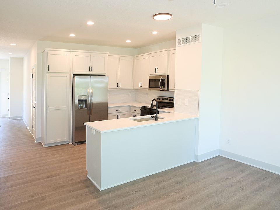 View from the living room of the kitchen and front hall beyond