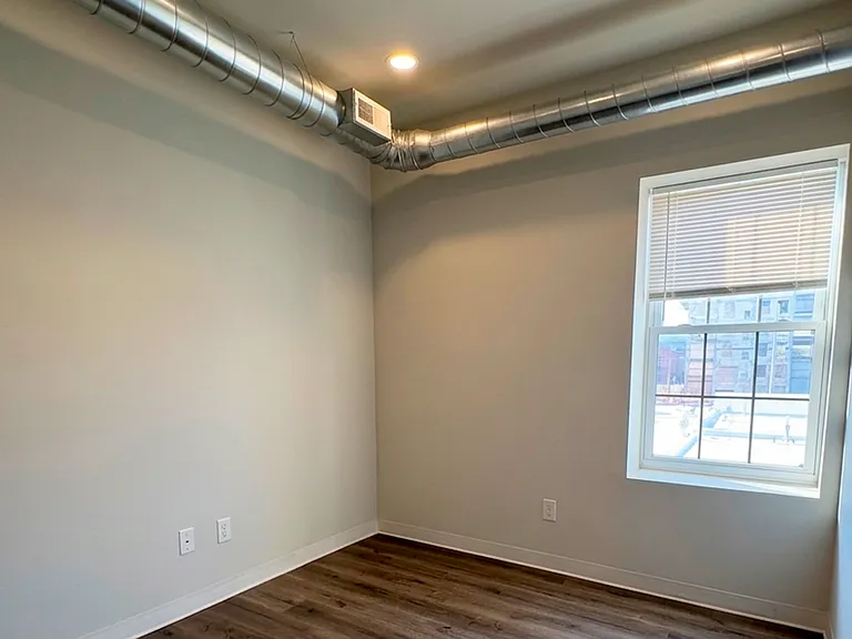Versatile room layout ready for your personal layout, complete with exposed ductwork.