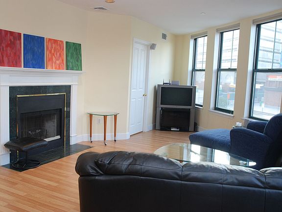 Livingroom with fireplace and wraparound windows
