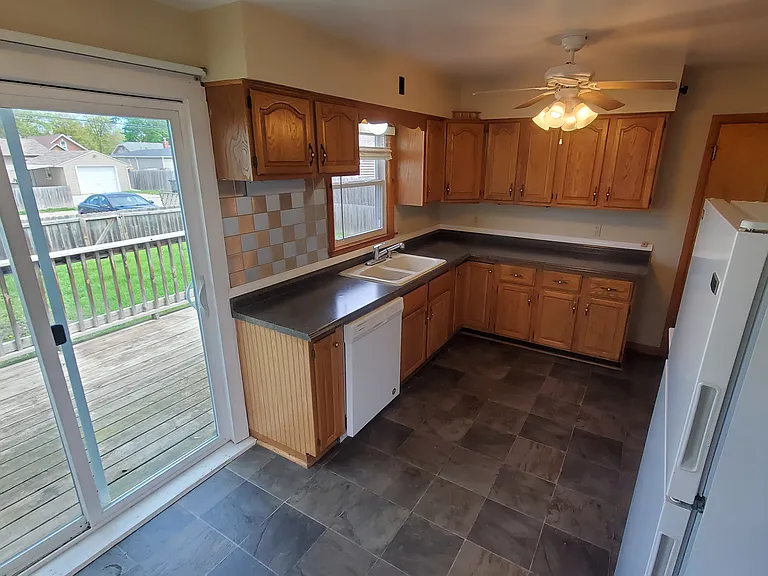 Kitchen - Main level. Patio Slider door on the left to 8' x 12' deck overlooking back fenced yard.