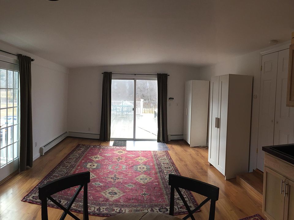 living room with kitchen and entrance to deck