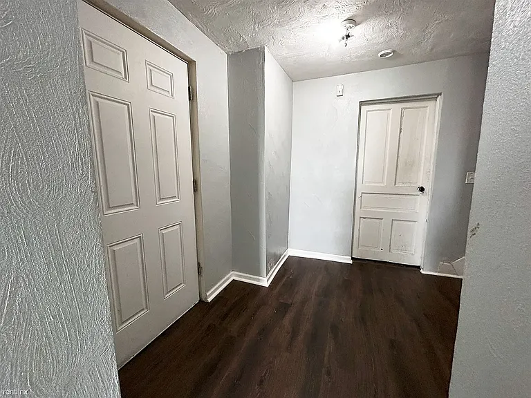 Hallway on bottom level showing exterior door and laundry room door