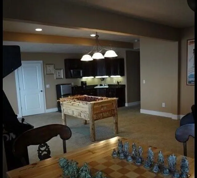 game room with chess table, fuse ball and kitchenette