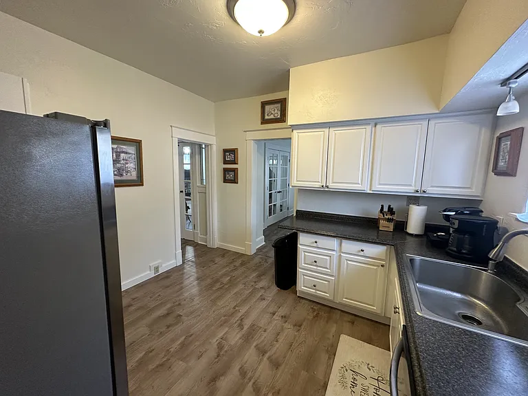 The kitchen flows seamlessly into the dining area, family room, and primary bedroom.