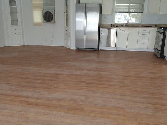 Open concept kitchen with luxury new plank flooring
