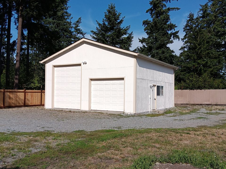 Large detached heated RV garage/workshop completly fenced 1/4 acre lot with gate.