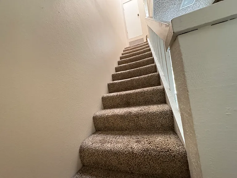 Stairs to second floor - brighten by a beautiful skylight.