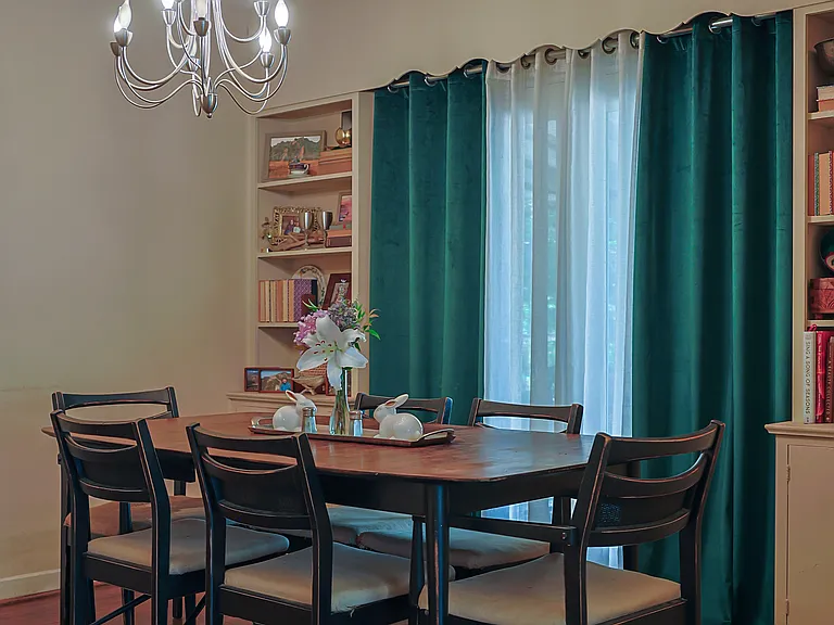 The dining room is spacious enough to hold a full buffet and dining table for 6. The built in bookshelves add additional storage space with closed cabinets below.