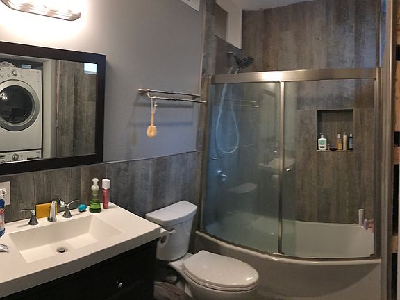 Tile shower w/ glass door and soaking tub