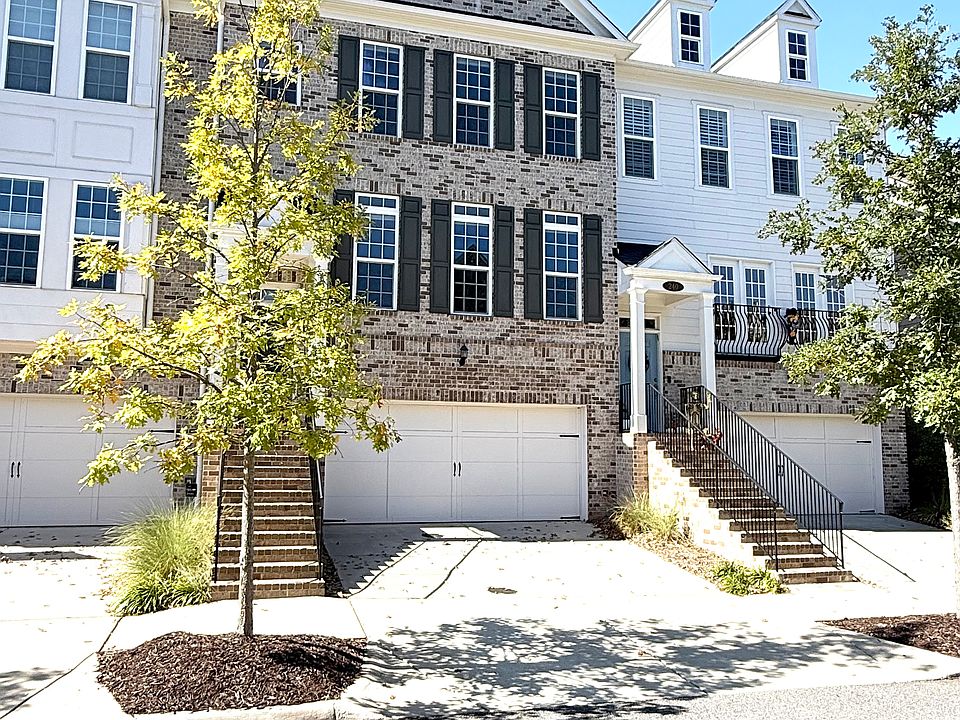 The Walk at Braeden. Elegant townhome exterior in Alpharetta's premier walkable community, steps from Avalon and the Alpha Loop.