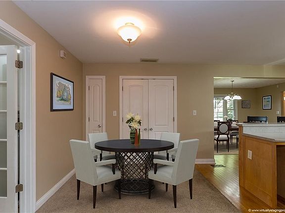 Breakfast nook off kitchen has been virtually staged for decorative purposes