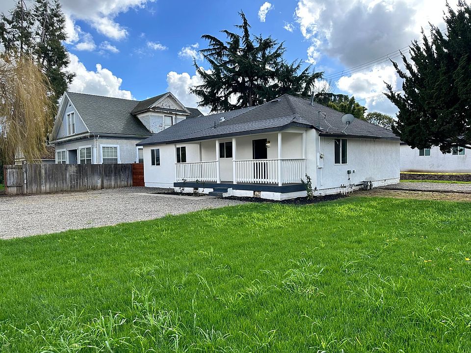Front of the home with beautiful porch and ample parking