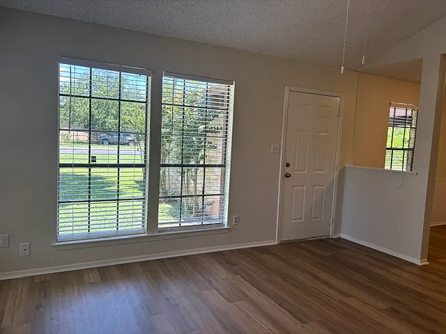Front entry door to Unit B. Living area with Dining area on the right.