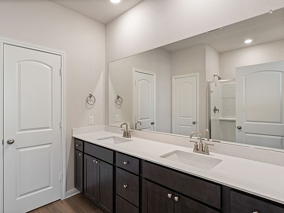 The master bathroom has a sprawling dual-sink vanity.