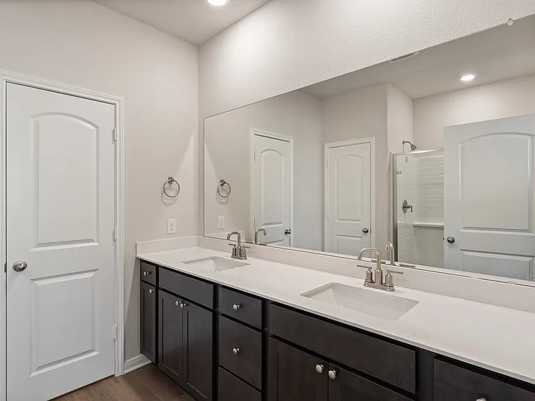 The master bathroom has a large dual-sink vanity.