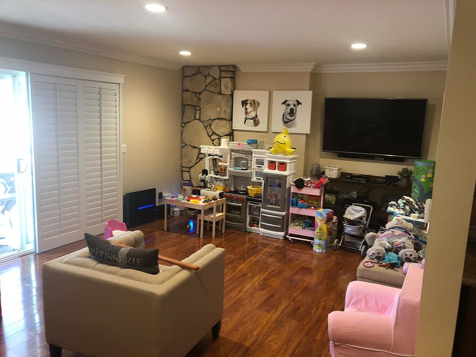 Living room with fireplace ( Behind Kitchen set), Sliding Glass door to backyard with sliding shutters.