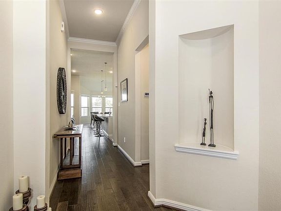 Dark wood flooring throughout the home give a luxurious warmth to the home. Neutral walls and high ceilings throughout. Architectural details lend caricature to the home.