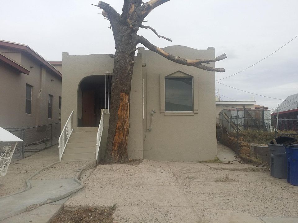 Street view in the process of removing tree, and cleaning yard.