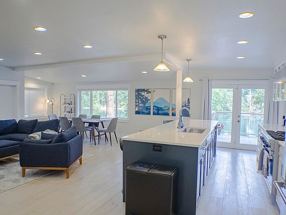 Kitchen and living room overlook the water and feature plenty of space for the whole family.