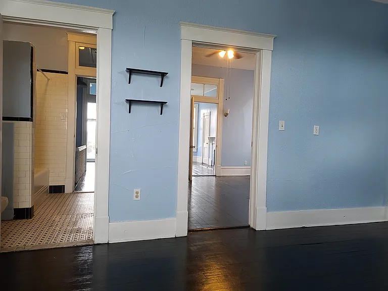 Kitchen facing bathroom on left and middle room on right.