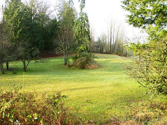 This vacant land is a .75 acre site ready for you to break ground and build your custom home. At the back of the cleared land in this photo is another parcel with 13,000 sq ft (.29 acre) that is also available and can be purchased for an additional $18,000. That parcel is on the east boundary and is the trees visible on the right of center in this photo.