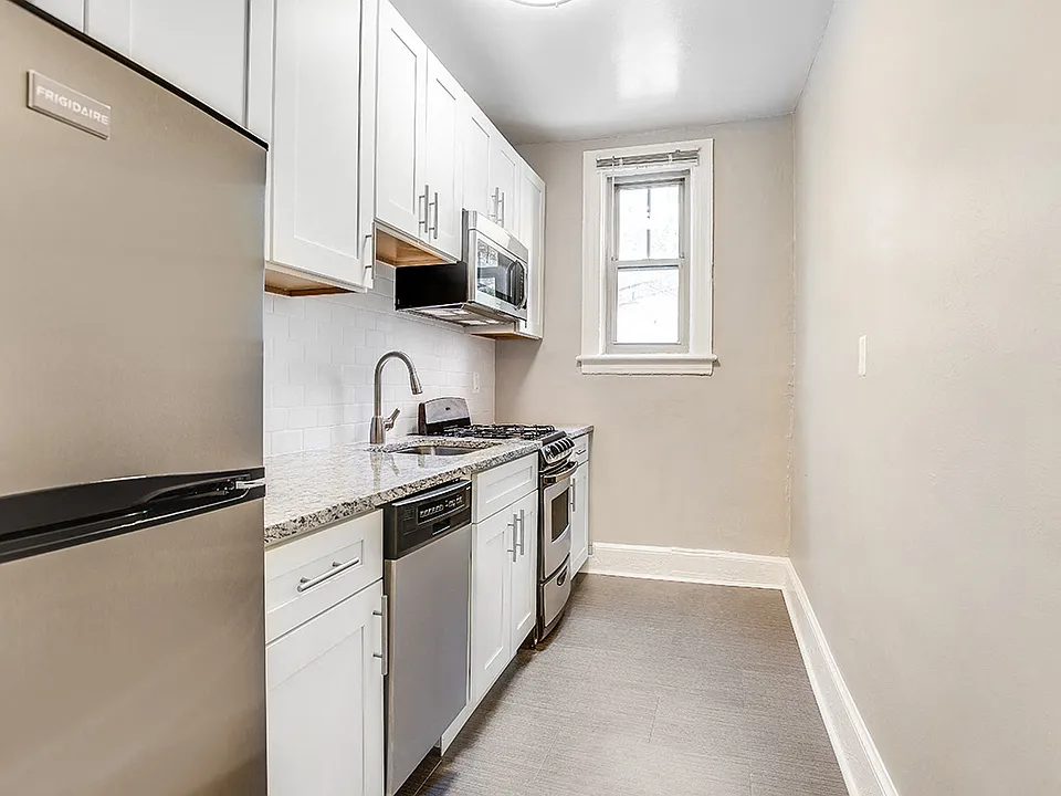 Renovated kitchen with granite countertops and stainless steel appliances