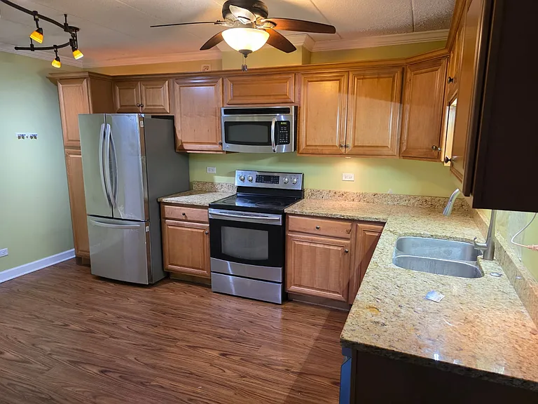 Spacious eat-in kitchen with big newer refrigerator and dishwasher.