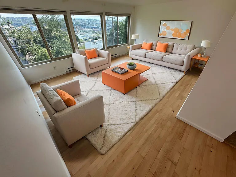 Living room with East facing windows and breathtaking panoramic views of South Lake Union