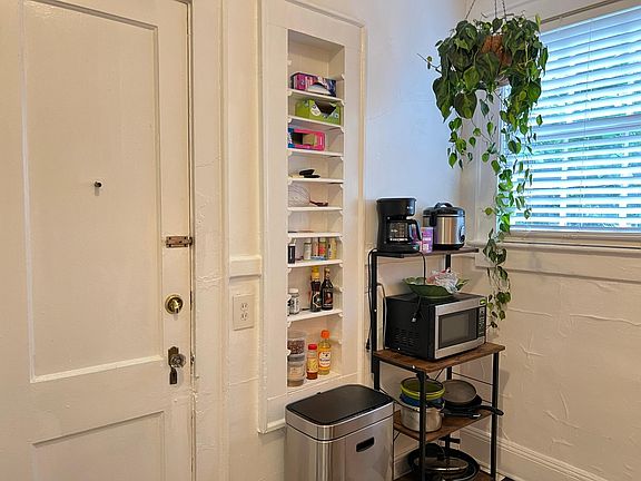 Adorable kitchen with backyard entrance and built-in spice cabinet