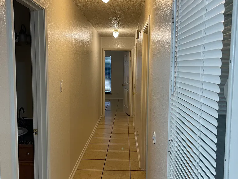 Hallway leading to master bdrm, with 2 other bdrms on right hand