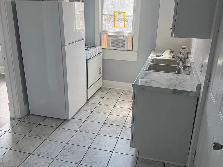 Unit A Kitchen with new stove, refrigerator, and microwave