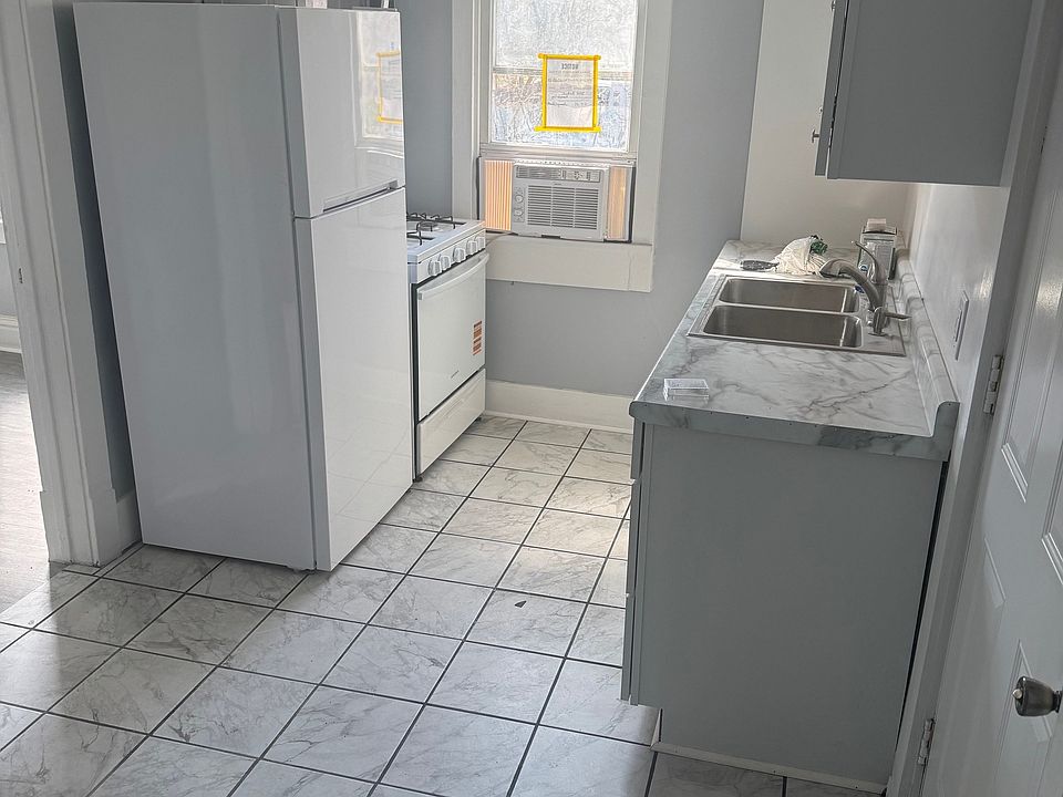 Unit A Kitchen with new stove, refrigerator, and microwave